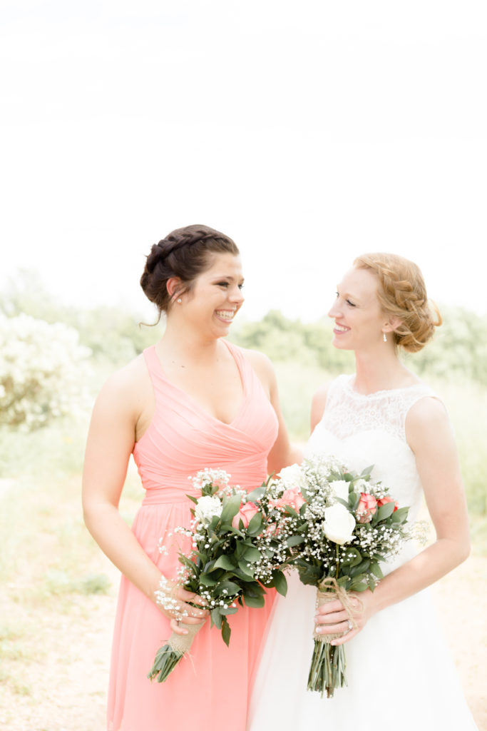 Bride and Bridesmaid share a look at each other at the Outpost center in Chaska