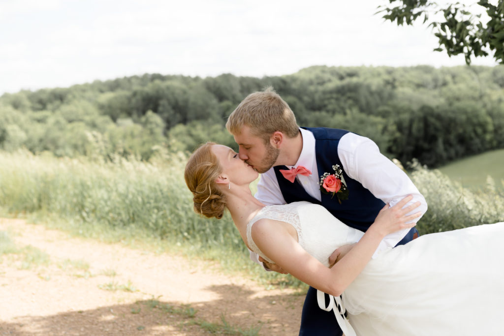 Bride and Groom share a dip kiss at the Outpost center in Chaska