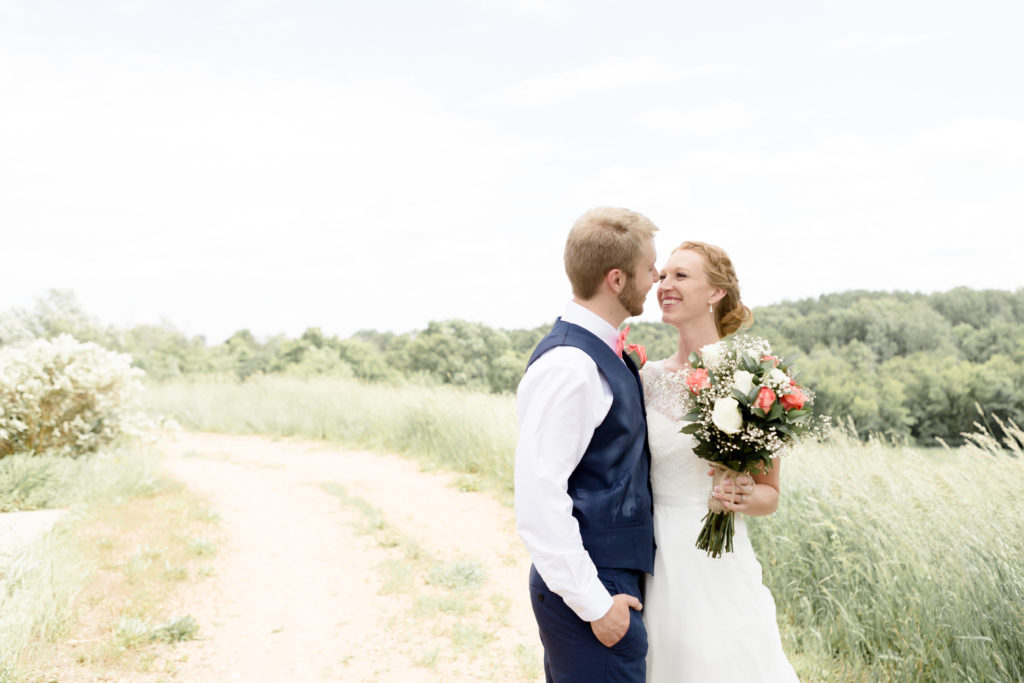 Bride and Groom share a look at each other at the Outpost center in Chaska