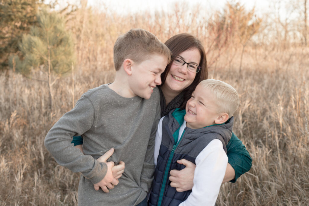 mom and boys hugging during family photos